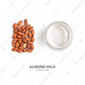 Creative layout made of almond milk and almonds on white background. Flat lay. Food concept.
