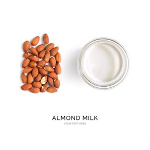 Creative layout made of almond milk and almonds on white background. Flat lay. Food concept.