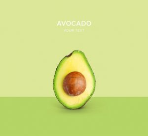 Creative layout made of avocado on the green background. Flat lay. Food concept. Macro  concept.