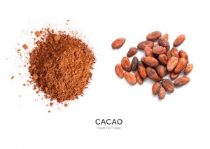 Creative layout made of cacao powder and cacao beans on the white background. Flat lay. Food concept. Macro concept.