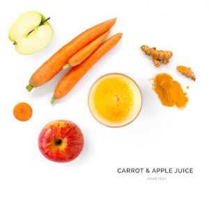 Creative layout made of carrot and apple juice. Flat lay. Food concept. Carrot and apple on the white background.