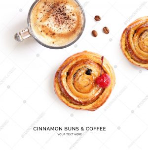 Creative layout made of cinnamon buns and cup of coffee on the white background. Flat lay. Food concept.