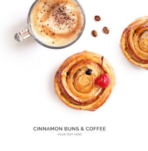 Creative layout made of cinnamon buns and cup of coffee on the white background. Flat lay. Food concept.