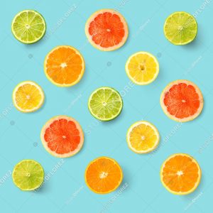 Creative layout made of lemon, lime, orange and grapefruit. Flat lay. Food concept. Lemon, lime, orange and grapefruit on turquoise background.