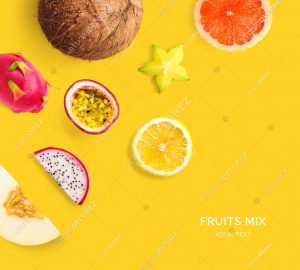 Creative layout made of lemon, grapefruit, pitahaya, passionfruit, melon, carambola and coconut. Flat lay. Food concept. Tropical fruits on the yellow background.