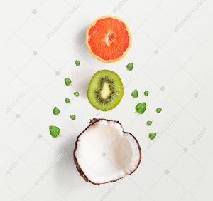 Creative layout made of summer tropical fruits and leaves. Flat lay. Food concept. Coconut, kiwi and grapefruit