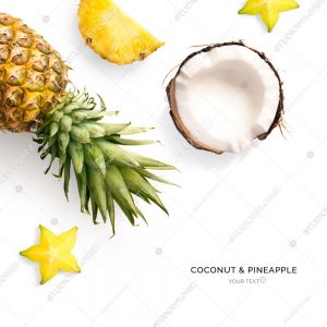 Creative layout made of carambola,  pineapple and coconut. Flat lay. Food concept. Tropical fruits on the white background.