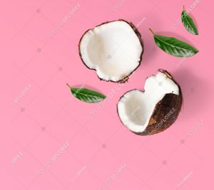 Creative layout made of coconuts and leaves. Flat lay. Food concept. Coconut on pink background.