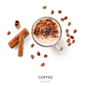 Creative layout made of coffee, coffee beans and cinnamon on white background. Flat lay. Food concept. Macro  concept.