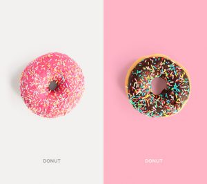 Creative layout made of pink and chocolate donuts. Flat lay. Food concept. Macro  concept.