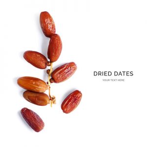 Creative layout made of dried dates on the white background. Flat lay. Food concept.