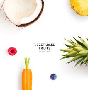 Creative layout made of carrot, coconut, raspberry and blueberry. Flat lay. Food concept.