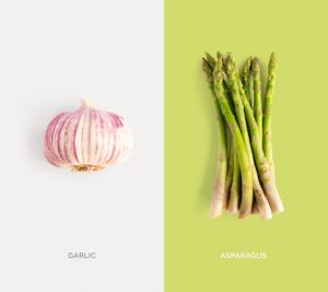 Creative layout made of garlic and asparagus on the white background. Flat lay. Food concept.