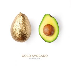 Creative layout made of gold avocado on the white background.  Tropical flat lay. Food concept.