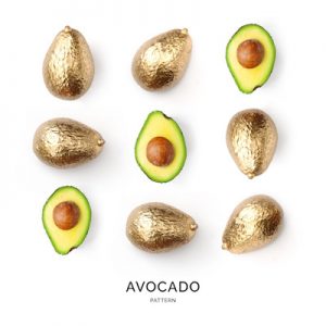Seamless pattern with gold avocado. Tropical abstract background. Gold avocado on the white background.
