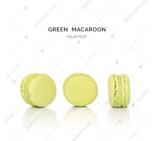 Creative layout made of green macaroons on the white background. Flat lay. Food concept.