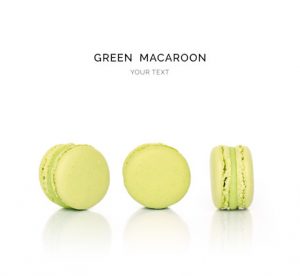 Creative layout made of green macaroons on the white background. Flat lay. Food concept.