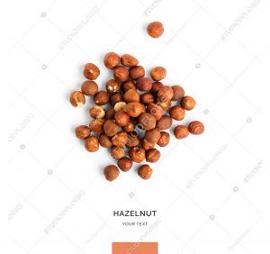 Creative layout made of hazelnut nuts on white background.Flat lay. Food concept.