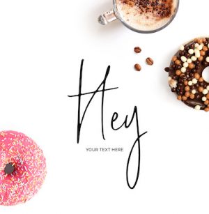 Creative layout made of  text "Hey". Food concept. Coffee and donuts on the white background.