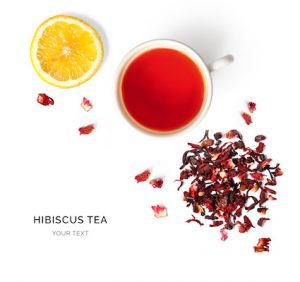 Creative layout made of cup of hibiscus tea and lemon on a white background. Top view.