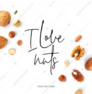 Creative layout made of  quote "I love nuts". Food concept. Hazelnut nuts, almonds, walnut, peanut, pecan, cashew on white background.