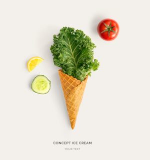 Ice cream cone with kale, tomato, cucumber and lemon. Flat lay. Food concept.