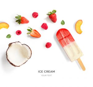Creative layout made of fruit ice cream, strawberry, raspberry and coconut. Flat lay. Food concept. Ice cream and fruits on white background.