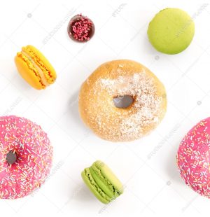 Seamless pattern made of macaroons and donut on the white background. Flat lay. Food concept.
