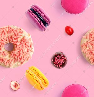 Seamless pattern made of macaroon and donut on the pink background. Flat lay. Food concept.