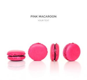 Creative layout made of pink macaroons on the white background. Flat lay. Food concept.