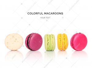Creative layout made of colorful macaroons on the white background. Flat lay. Food concept.