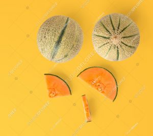 Creative layout made of melon. Flat lay. Food concept. Melon on the yellow background.
