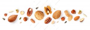 Creative layout made of hazelnut nuts, almonds, walnut, peanut, pecan, sunflower seeds on white background.Flat lay. Food concept.