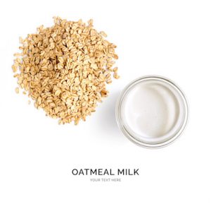 Creative layout made of oatmeal milk on white background. Flat lay. Food concept.