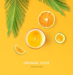 Creative layout made of orange juice. Flat lay. Food concept. Orange juice and fruits on yellow background.