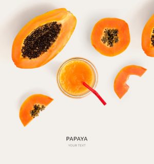 Creative layout made of papaya smoothie. Flat lay. Food concept. Papaya on the light background.