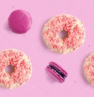 Seamless pattern made of purple macaroon and pink donut. Flat lay. Food concept.