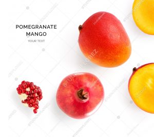 Creative layout made of mango and pomegranate. Flat lay. Food concept. Mango and pomegranate on white background.