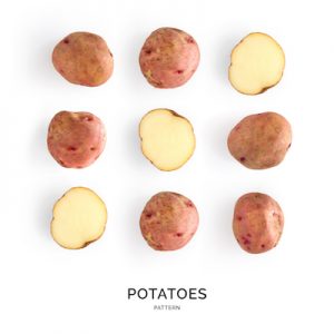 Seamless pattern with potatoes. Vegetables abstract background. Potatoes on the white background.