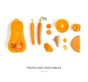 Creative layout made of pumpkin, carrot, orange, melon, apricot and turmeric. Flat lay. Food concept. Orange fruit and vegetables isolated on white background.