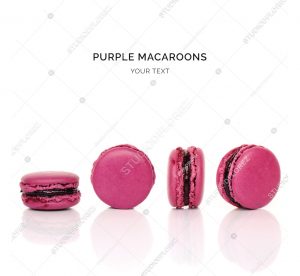 Creative layout made of purple macaroons on the white background. Flat lay. Food concept.