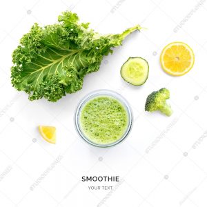 Creative layout made of kale, cucumber and broccoli smoothie. Flat lay. Food concept. Smoothie on the white background.