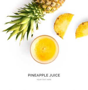 Creative layout made of pineapple juice. Flat lay. Food concept. Smoothie on the white background.