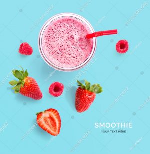 Creative layout made of raspberry, strawberry and coconut smoothie. Flat lay. Food concept. Smoothie on the blue background.