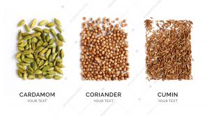 Creative layout made of cardamon, coriander and cumin. Flat lay. Food concept. Cardamon, coriander and cumin on the white background.