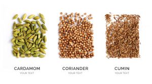 Creative layout made of cardamon, coriander and cumin. Flat lay. Food concept. Cardamon, coriander and cumin on the white background.