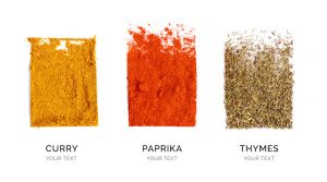 Creative layout made of curry, paprika and thyme. Flat lay. Food concept. Thyme, paprika and curry powder on the white background.