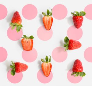 Seamless pattern with strawberry. Tropical abstract background. Strawberry on the light background with pink dots.