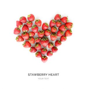 Creative layout made of strawberries in the shape of heart . Food concept. Strawberry on the white background.