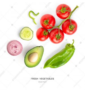 Creative layout made of tomato, onion, green pepper, cucumber and avocado. Flat lay. Food concept. Vegetables isolated on white background.